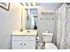 Bathroom featuring a white vanity, mirror, toilet, shower curtain, and neutral gray walls at 6203 Catalina Dr. # 1811, North Myrtle Beach, SC 29582