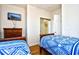 Cozy bedroom featuring two twin beds, a dresser with a TV, and a closet with sliding doors at 6203 Catalina Dr. # 1811, North Myrtle Beach, SC 29582
