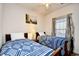 Bedroom featuring two beds with decorative patterned blankets, a side table, and a window at 6203 Catalina Dr. # 1811, North Myrtle Beach, SC 29582