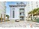 Exterior of property with reserved parking spaces, palm trees, and building sign at 6203 Catalina Dr. # 1811, North Myrtle Beach, SC 29582