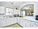 A bright kitchen features white cabinets, tiled floors, and a window at 6203 Catalina Dr. # 1811, North Myrtle Beach, SC 29582