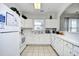Bright kitchen with white cabinetry, neutral tile flooring, and ample counter space at 6203 Catalina Dr. # 1811, North Myrtle Beach, SC 29582