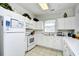 A bright kitchen features white cabinets, tiled floors, and plenty of storage at 6203 Catalina Dr. # 1811, North Myrtle Beach, SC 29582