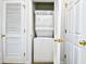 A stackable washer and dryer in a laundry closet surrounded by white doors with golden knobs at 6203 Catalina Dr. # 1811, North Myrtle Beach, SC 29582