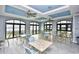 Bright lounge area featuring tables, chairs, ceiling fans, and large ocean view windows at 6203 Catalina Dr. # 1811, North Myrtle Beach, SC 29582