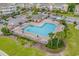 Aerial view of a community pool surrounded by lounge chairs and palm trees at 6203 Catalina Dr. # 1811, North Myrtle Beach, SC 29582