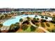 Aerial view of a large community pool with tropical landscaping and lounge chairs at 6203 Catalina Dr. # 1811, North Myrtle Beach, SC 29582