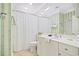 Bright bathroom features tiled floors, white cabinets, and a shower with a decorative shower curtain at 63 Mckissick Dr. # 2B, Pawleys Island, SC 29585