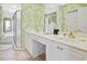 Well-lit bathroom with double vanity, walk-in shower, soaking tub, and tropical wallpaper at 63 Mckissick Dr. # 2B, Pawleys Island, SC 29585