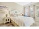Charming bedroom with a white wooden headboard, floral pillows, bedside tables, and plenty of natural light at 63 Mckissick Dr. # 2B, Pawleys Island, SC 29585