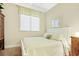Comfortable bedroom featuring a full size bed, window with blinds, and tasteful decor at 63 Mckissick Dr. # 2B, Pawleys Island, SC 29585