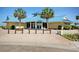 Inviting clubhouse exterior with a striking blue roof, surrounded by palm trees and landscaped entrance at 63 Mckissick Dr. # 2B, Pawleys Island, SC 29585