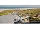 Relaxing deck with white seating overlooking a picturesque beach, perfect for enjoying coastal views at 63 Mckissick Dr. # 2B, Pawleys Island, SC 29585