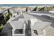 Spacious deck with white chairs and lounge chairs offer a great view of the expansive beach area at 63 Mckissick Dr. # 2B, Pawleys Island, SC 29585
