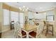 Dining area with decorative chandelier, windows and eat-in kitchen at 63 Mckissick Dr. # 2B, Pawleys Island, SC 29585