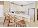 Bright eat-in kitchen featuring white cabinetry and breakfast bar at 63 Mckissick Dr. # 2B, Pawleys Island, SC 29585