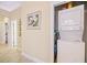 A hallway laundry area with a stacked washer and dryer tucked neatly behind a door at 63 Mckissick Dr. # 2B, Pawleys Island, SC 29585