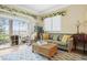 Cozy living room featuring a comfortable sofa, rattan coffee table, and sliding glass doors to an outdoor balcony at 63 Mckissick Dr. # 2B, Pawleys Island, SC 29585