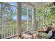 Comfortable screened porch with inviting seating and a serene view of the surrounding landscape at 63 Mckissick Dr. # 2B, Pawleys Island, SC 29585