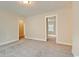 Spacious bedroom with neutral carpet, bright lighting, and two doorways at 67 Bridgeview Rd., Georgetown, SC 29440