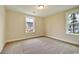 Bright bedroom featuring neutral walls, carpeted floor, and two windows at 67 Bridgeview Rd., Georgetown, SC 29440