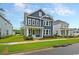 Charming two-story blue home with manicured lawn, complemented by white trim and welcoming porch at 67 Bridgeview Rd., Georgetown, SC 29440