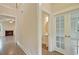 Hallway with hardwood floors leading to a half-bathroom and living room with a fireplace at 67 Bridgeview Rd., Georgetown, SC 29440