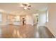 Open-concept living room featuring hardwood floors, neutral walls, and a view of the kitchen at 67 Bridgeview Rd., Georgetown, SC 29440