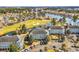 Beautiful aerial view of condos, golf course, pond, and water in a scenic community setting at 699 Riverwalk Dr. # 202, Myrtle Beach, SC 29579