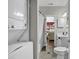 The well-lit bathroom features a combination washer/dryer, and a shower and tub combo at 699 Riverwalk Dr. # 202, Myrtle Beach, SC 29579