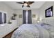 The bedroom is cozy and well-lit, features a ceiling fan and dresser with mirror at 699 Riverwalk Dr. # 202, Myrtle Beach, SC 29579