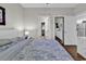 A light-filled bedroom featuring hardwood floors with access to the bathroom and kitchen at 699 Riverwalk Dr. # 202, Myrtle Beach, SC 29579