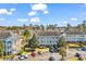 Condominium building with a parking lot, nice lawns and mature trees at 699 Riverwalk Dr. # 202, Myrtle Beach, SC 29579