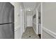Hallway featuring modern tile flooring, access to rooms, and stainless steel fridge at 699 Riverwalk Dr. # 202, Myrtle Beach, SC 29579