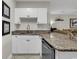 Well-equipped kitchen with granite counters, white cabinets and stainless steel appliances at 699 Riverwalk Dr. # 202, Myrtle Beach, SC 29579