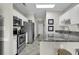 Bright kitchen featuring granite countertops, stainless steel appliances, and white cabinetry at 699 Riverwalk Dr. # 202, Myrtle Beach, SC 29579