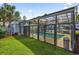 Enclosed community pool, next to a grassy lawn and palm trees at 699 Riverwalk Dr. # 202, Myrtle Beach, SC 29579