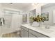 Bright bathroom features double sinks, white cabinetry, and a shower-tub combo at 7071 Shooting Star Way, Myrtle Beach, SC 29579