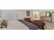 A well-lit bedroom featuring a plush bed, sitting area and en-suite bathroom for added comfort at 7071 Shooting Star Way, Myrtle Beach, SC 29579