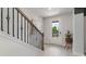 Inviting entryway featuring a staircase with decorative iron railings and light wood flooring at 7071 Shooting Star Way, Myrtle Beach, SC 29579