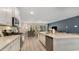 Modern kitchen featuring sleek appliances, a center island, and an open layout to living room at 7071 Shooting Star Way, Myrtle Beach, SC 29579