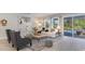 Bright living room with large sliding doors leading to a pool and outdoor entertainment area at 7071 Shooting Star Way, Myrtle Beach, SC 29579