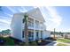 Corner lot home featuring a double porch, well manicured landscaping, and two-car garage at 7079 Shooting Star Way, Myrtle Beach, SC 29579