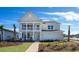 Charming two-story home with double front porches and a well-manicured lawn at 7079 Shooting Star Way, Myrtle Beach, SC 29579