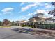 Community clubhouse with manicured landscaping and a charming cupola, set against a blue, partly cloudy sky at 7079 Shooting Star Way, Myrtle Beach, SC 29579