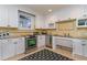 Well-lit kitchen features white cabinets, stainless steel appliances, granite countertops, and patterned backsplash at 7079 Shooting Star Way, Myrtle Beach, SC 29579