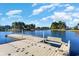 Scenic water view featuring a dock, lush greenery, and waterfront homes under a blue sky at 7079 Shooting Star Way, Myrtle Beach, SC 29579