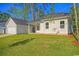 Backyard featuring a well-maintained lawn, a detached garage and a home with white siding at 82 Bridgeview Rd., Georgetown, SC 29440