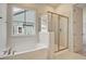 Bathroom with tub, glass shower, and natural light at 82 Bridgeview Rd., Georgetown, SC 29440