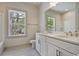 Bathroom with dual sink vanity, a large mirror, natural light, and a shower-tub combo at 82 Bridgeview Rd., Georgetown, SC 29440